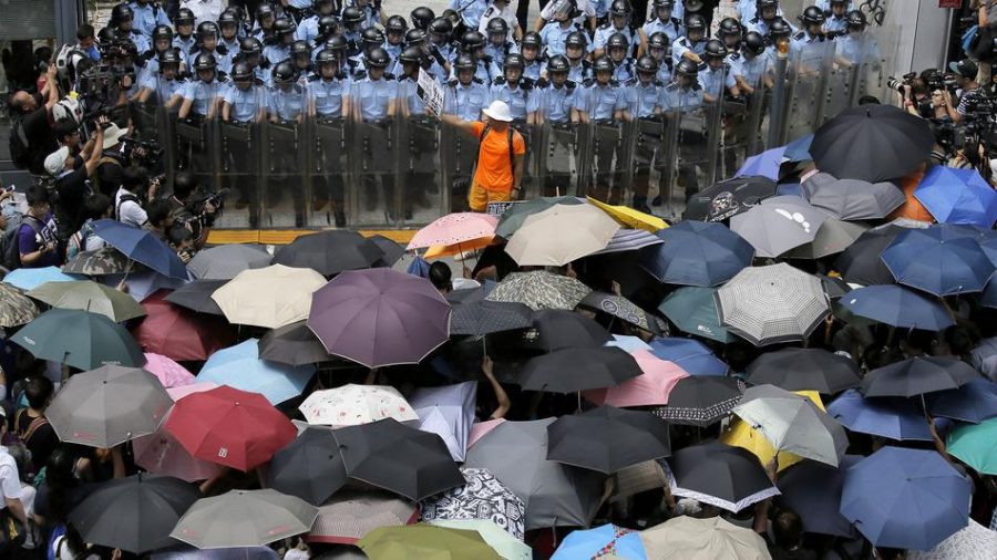 The+Hong+Kong+protestors+flood+the+streets+using+umbrellas+to+cover+their+faces+from+pepper+spray.