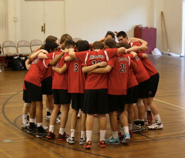 Mens Varsity Volleyball huddled together discussing their plan for the game. Photo Courtesy YLHSmensvolleyball.com