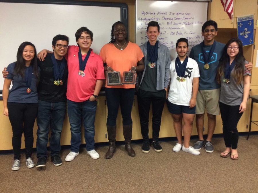 The+YLHS+Academic+Decathlon+team+posing+with+advisor%2C+Ms.+Stephenson%2C+and+their+awards+from+the+competition.