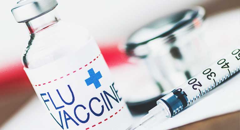 The flu vaccine, photo courtesy of Healthline
