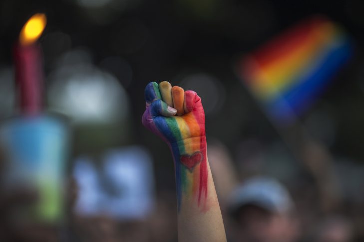 A fist raises in defiance at a vigil for the victims of the Orlando shooting.