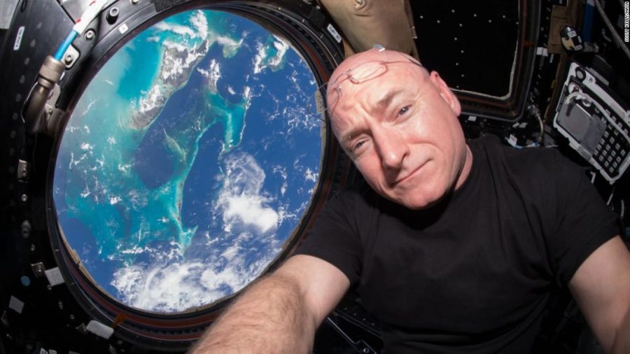 Kelly poses with his astonishing view of Earth, with just a month left on his journey in the vast world of space.
