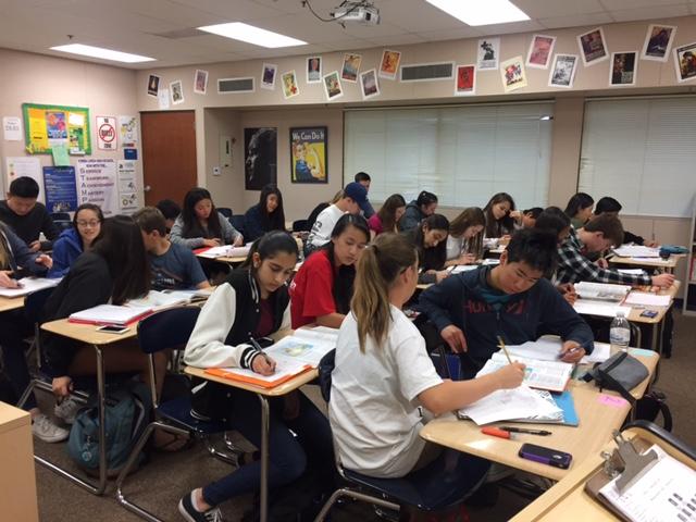 The students of AP Human Geography work diligently on an assignment in class.