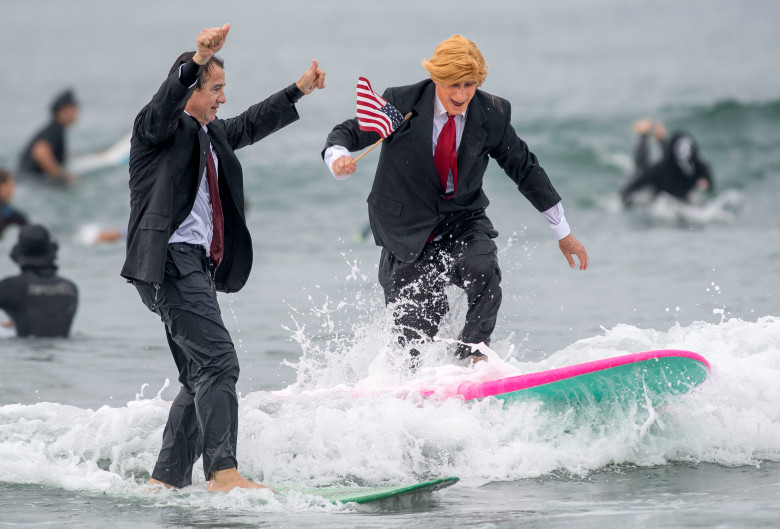 Local Surfer Gary Crane and friends get in the holiday spirit with a costume of Donald Trump waving an American Flag.