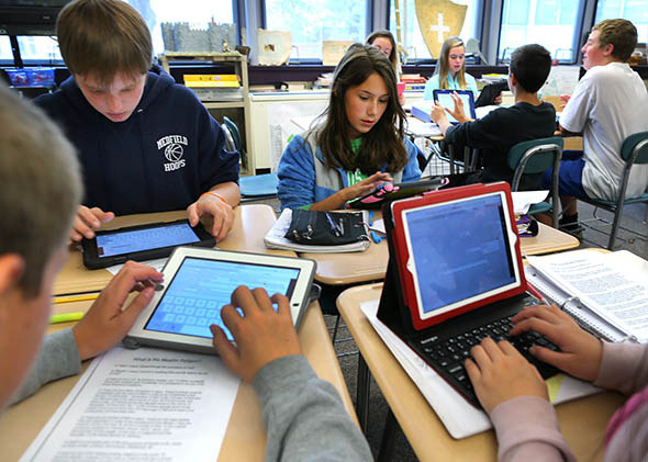 Students in teacher Cynthia McClellans eighth grade social science and history class at the Blake Middle School use their iPads during class.