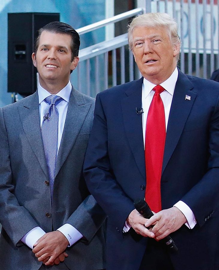Donald Trump and his son Donald Trump Jr. speak to a crowd about building the wall. 