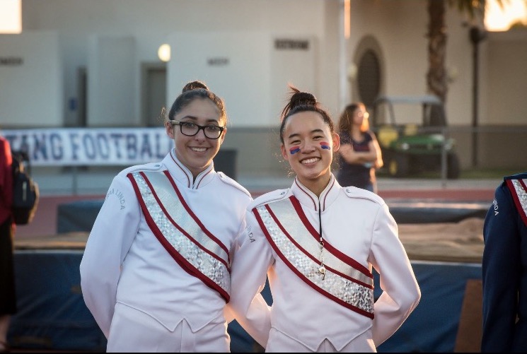 Emily Di Bias (11) and Natalie Suvarnasuddhi (11) in their drum major uniforms.