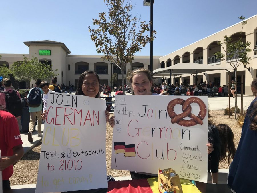 Jade Low (11) and Allie Mortenson (11) excitedly promote German Club during club rush.  