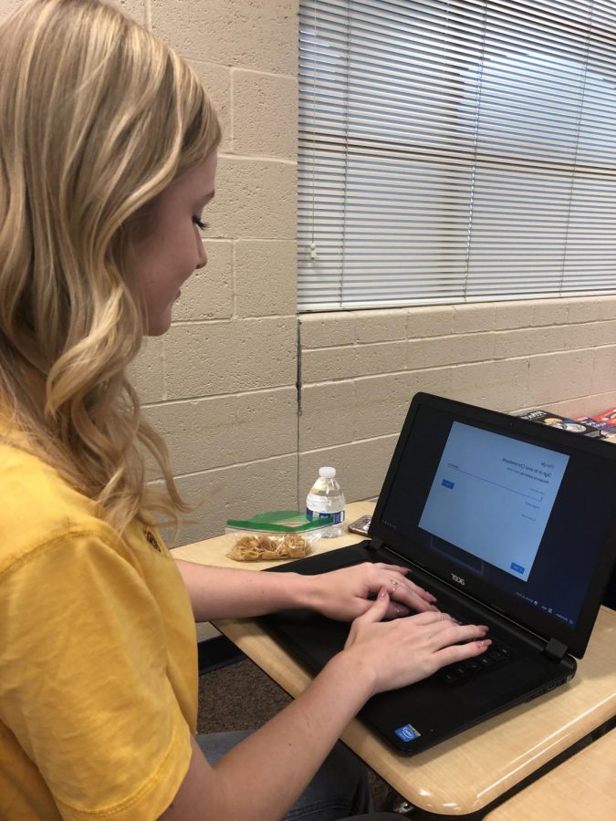 Payton Janish (12) logs into a Chromebook to work on her assignment during class.