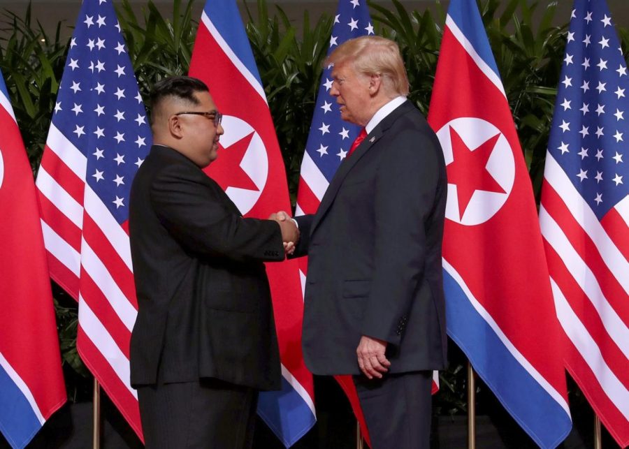 Trump+and+Kim+in+the+First+Summit+with+a+friendly+handshake.+%28credits+to+nationalinterest.org%29