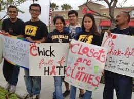 People outside of Chick-fil-A with protesting signs(photo courtesy of The Socialist Worker)