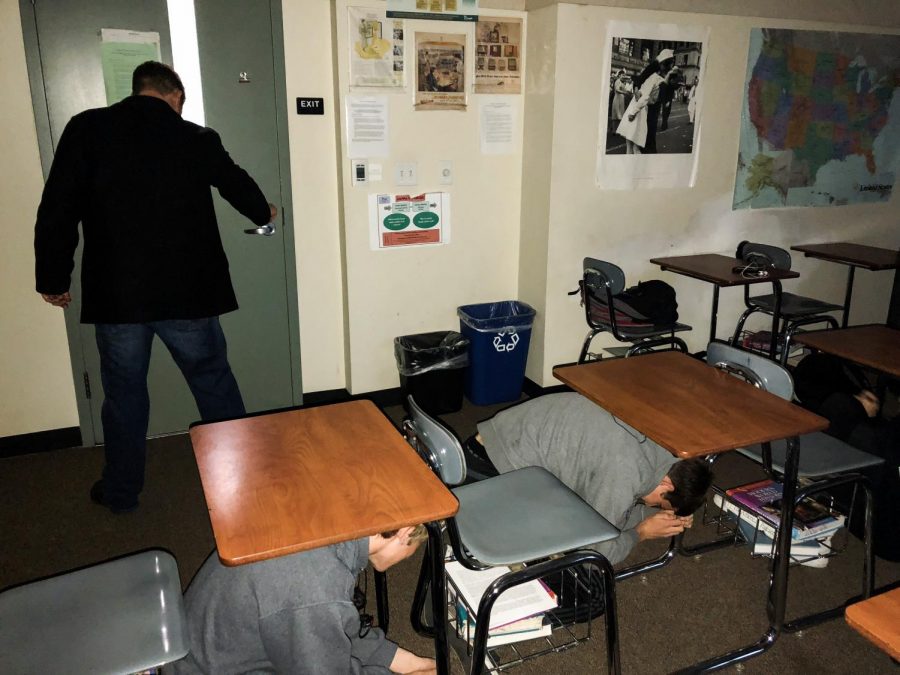 Students at Coronado High School hide beneath their desks during a school lockdown drill. 