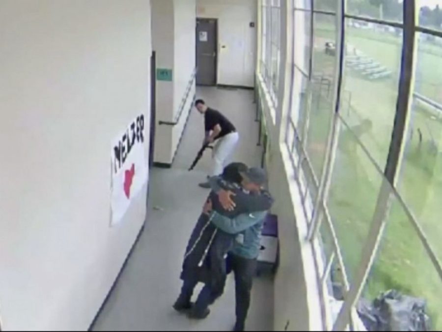 A still from security camera footage showing Keanon Lowe hugging Angel Granados-Diaz.