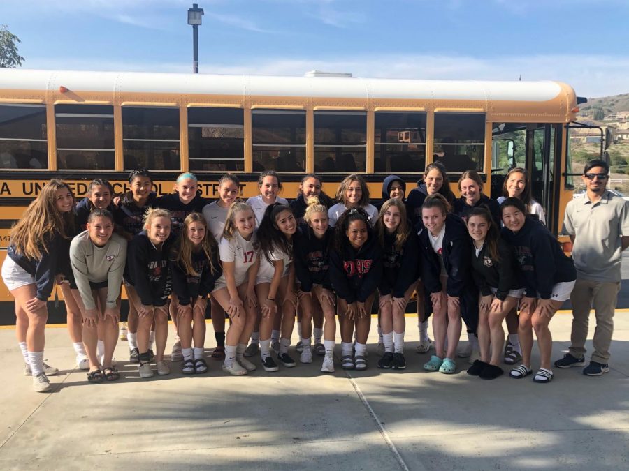 The team prepares to travel to Rancho Cucamonga and play they second round game by taking a team photo in front of their team bus.