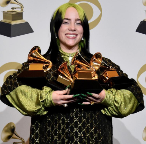 Billie Eilish can not help but smile as she shows off her five Grammys.