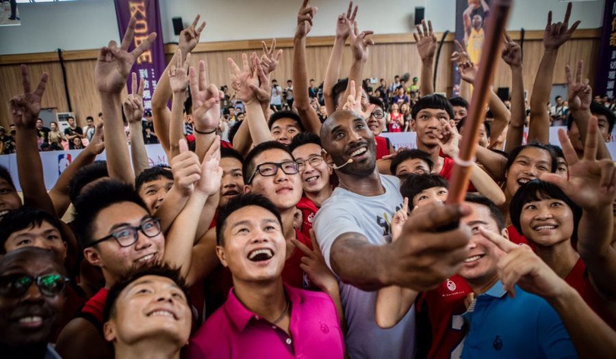 Kobe+takes+a+picture+with+some+of+his+youth+fans+during+the+grand+opening+of+his+new+%E2%80%9Cbasketball+school%E2%80%9D+in+Haikou%2C+China%2C+during+2017.