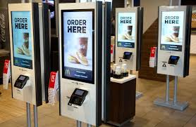 The use of Artificial Intelligence is seen at fast-food chains where ordering kiosks are used, which replaces cashiers.