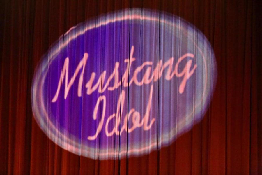 Family and friends take their seats as this custom Mustang Idol logo shines on the curtain.