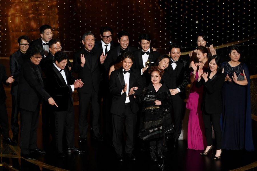 The cast of Parasite celebrates receiving Best Picture on stage at the 2020 Academy Awards.