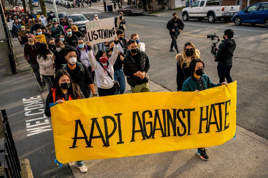 Protestors march together to fight against hate towards the AAPI community.