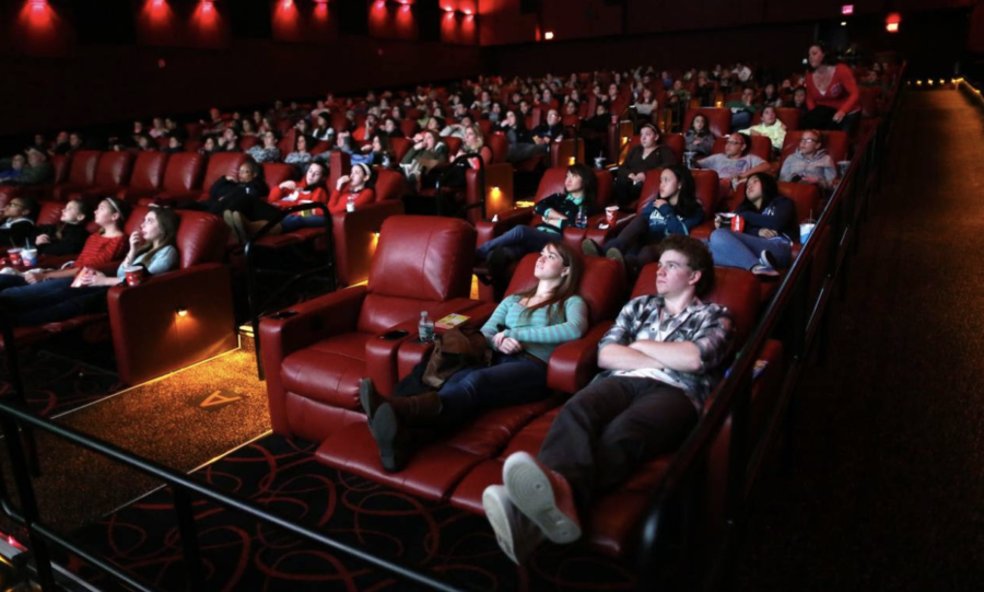A full theater of viewers gather to watch a movie pre-covid.
