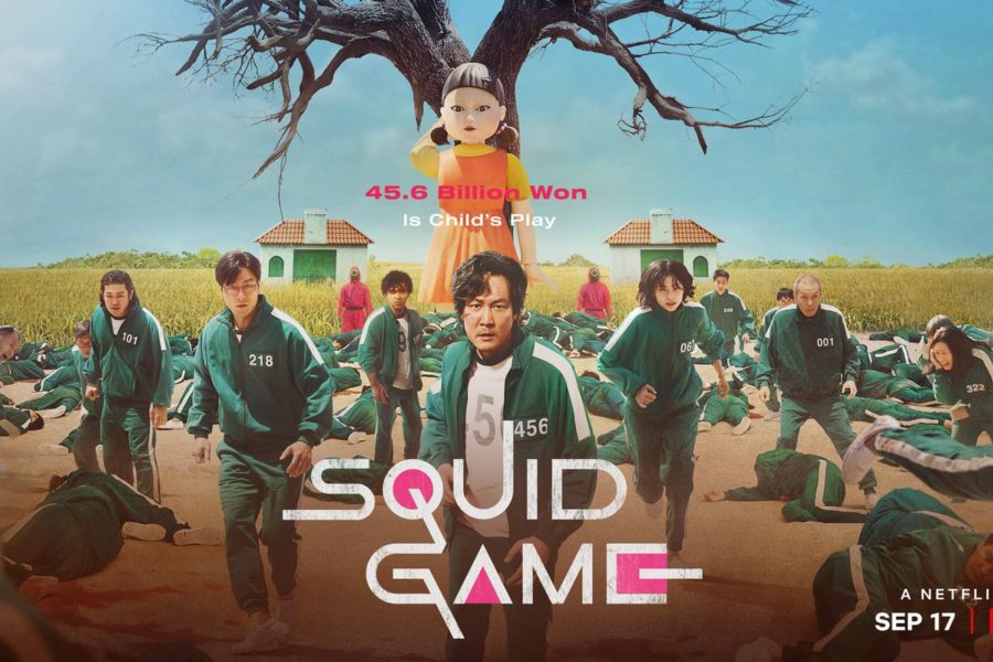 The cover poster for Squid Game. The three main characters, Seong Gi-hun, Cho Sang-woo, and Kang Sae-byeok, stand in the center of the arena during the show’s most famous scene.