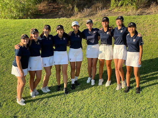 The varsity golf team smiles for a photo after a successful match.