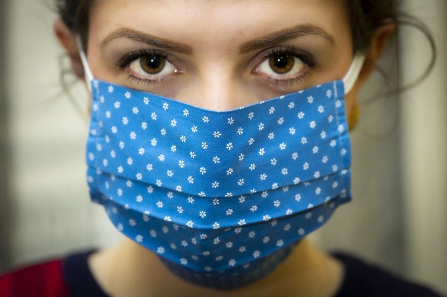 The standard viewpoint of a modern-day woman and the appearance of a medical mask covering her face.