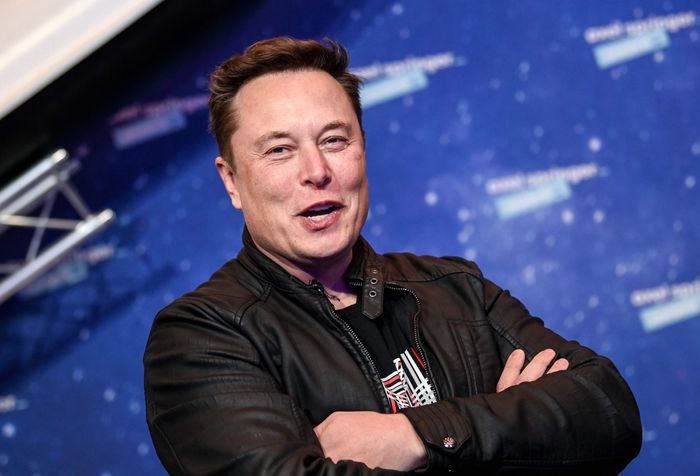 Elon Musk posing in his signature crossed-arms position. This particular photo was taken at a forum where Musk explained his various reasons for purchasing Twitter.