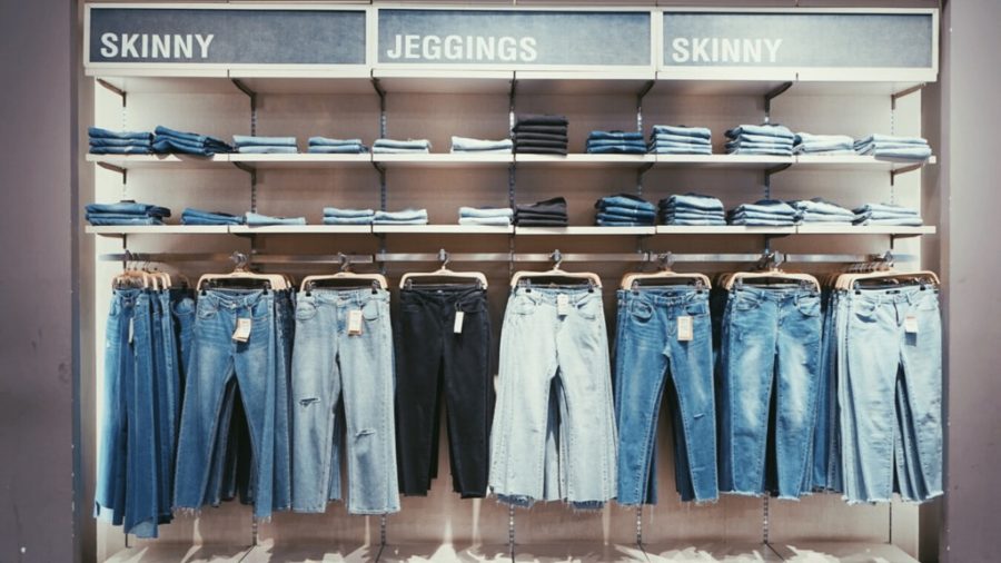 A variety of skinny jeans on display sold in a shop.