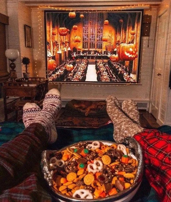  People watch Harry Potter as they enjoy a couple of fall snacks.