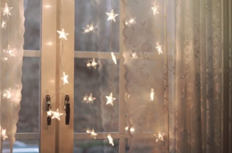 A bedroom window decorated with led stars gives the bedroom a perfect cozy space to sleep and maybe dream in 