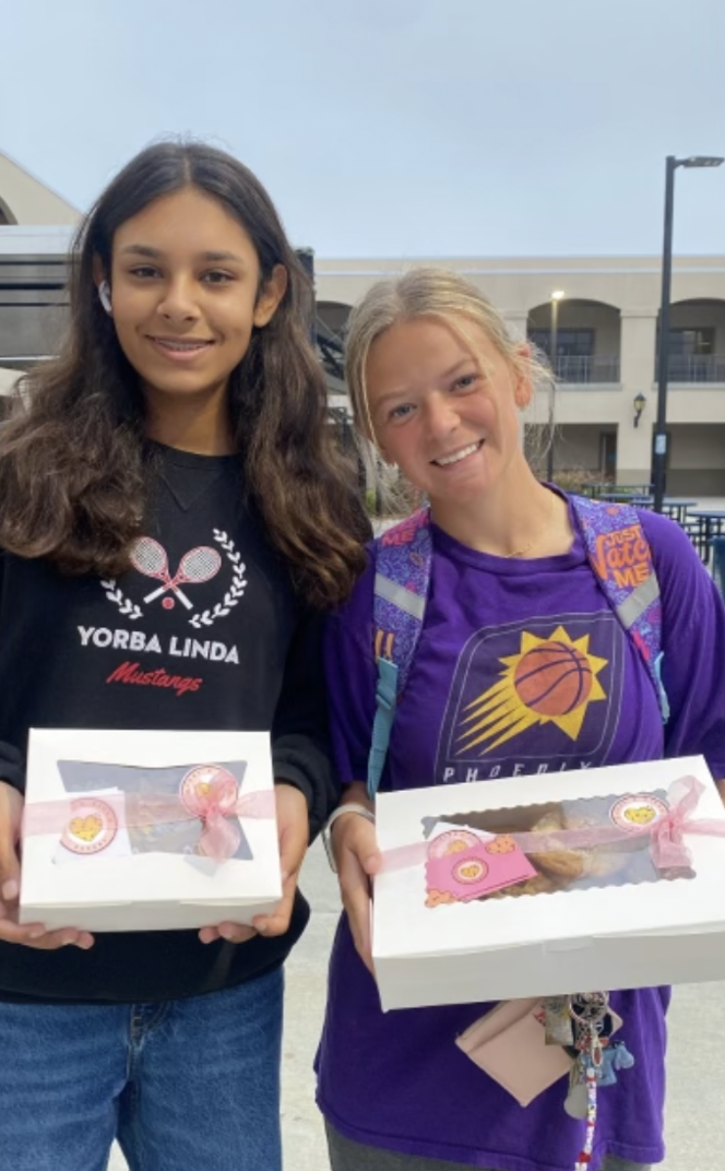 Simran Vaswani (10) and Emma Perron (12) with their boxes of cookies!
