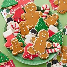 Decorated sugar cookies are displayed on a plate on Christmas morning.

