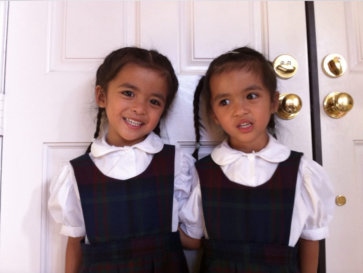 Jennalyn Urquico (11) and Lauren Urquico (12) in 2011, wearing matching school uniforms on their first day of school.