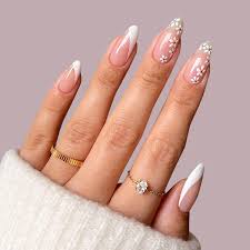 Stylish acrylic nails are displayed about with cute flower designs. 