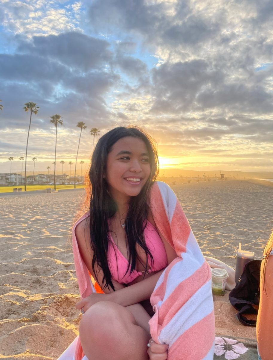 Jennalyn Urquico (11) watching the beach sunrise after taking a morning swim.