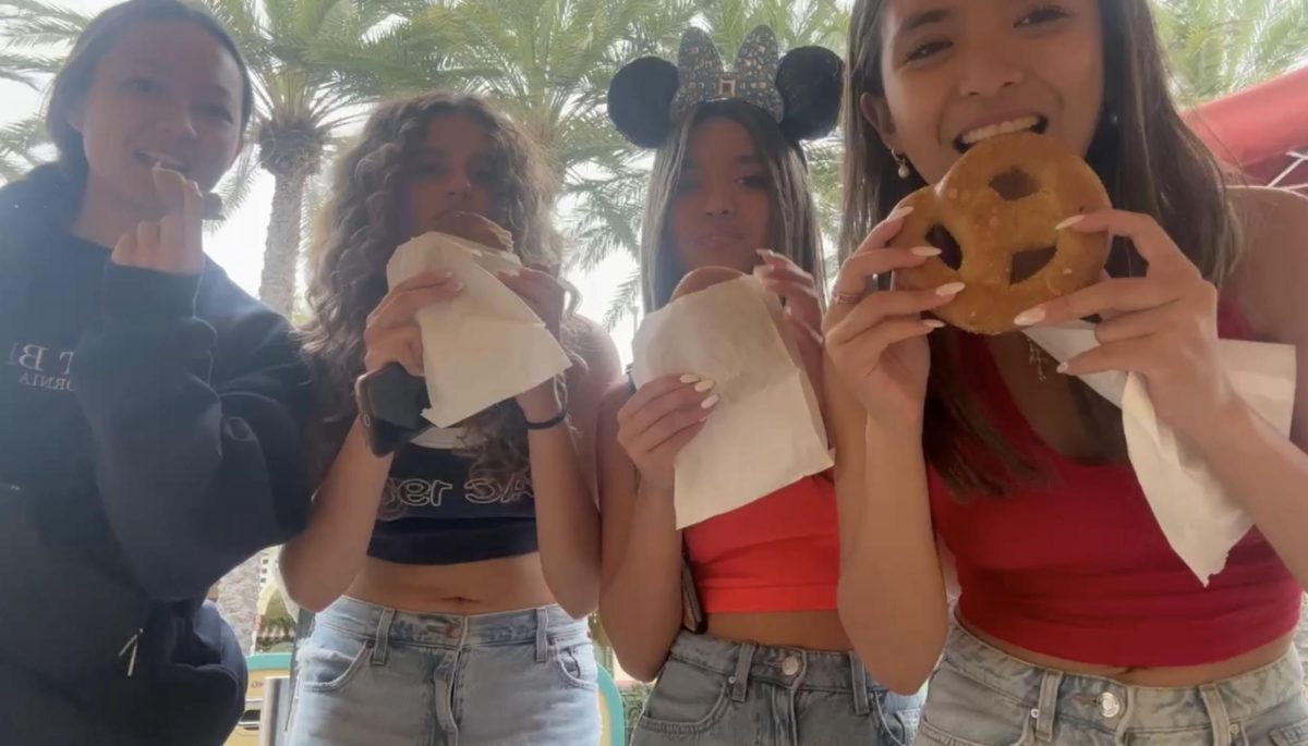 (from left to right) Chloe Chang (11), Faith Alam (11), Lauren Urquico (11), and Jennalyn Urquico (11) taking their first bite out of the sweet cream cheese pretzel–one of the treats at DCA.
