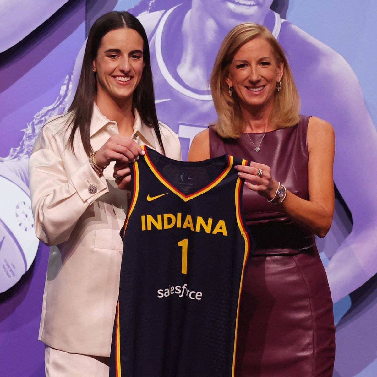 The WNBA’s number one pick for the draft, Caitlin Clark, takes a picture signing with her team Indiana Fever.
