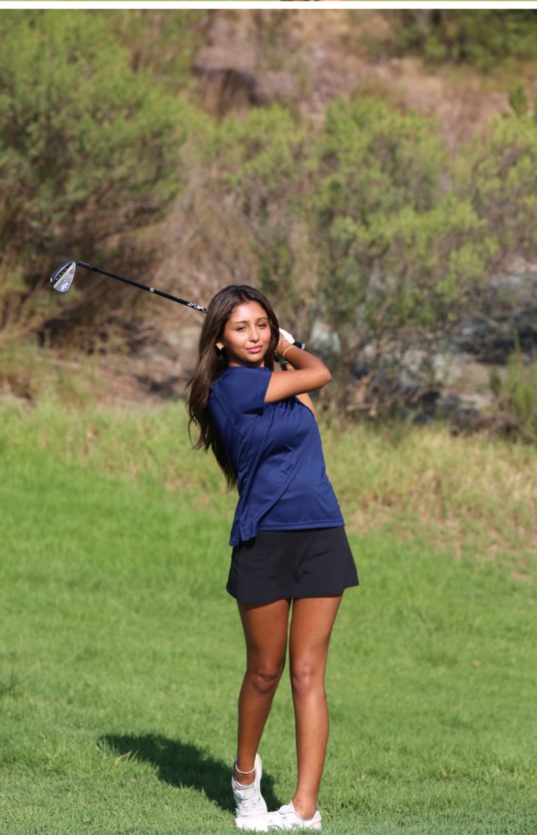 Navi Gupta (12) watching her ball after she fired it towards her target