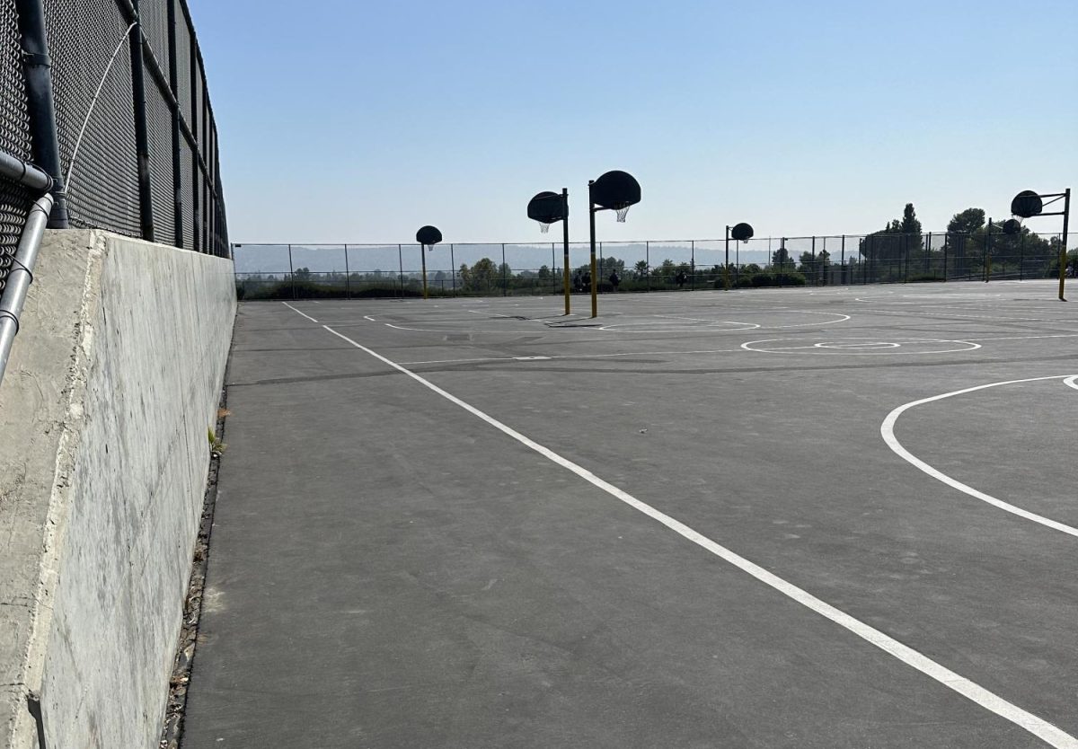 The Yorba Linda High School outdoor basketball court is paved fully with asphalt. 