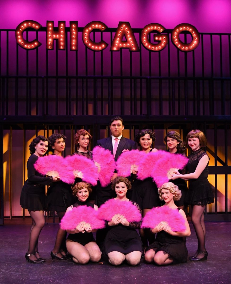 Excited, some girls of the cast crowd around leading male Andrew Gardner who plays crinimal lawyer Billy Flynn! 