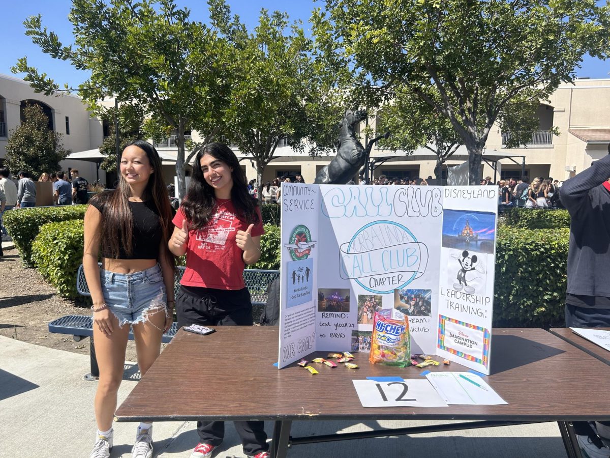 Co-Presidents (from left to right) Chloe Chang (12) and Christie Kilaghbian (12) advertise their club, CALL Club, to their fellow students during the 2024-2025 YLHS Club Rush.