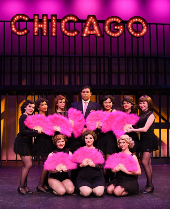 Excited, some girls of the cast crowd around leading male Andrew Gardner who plays crinimal lawyer Billy Flynn! 
