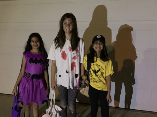 This photo depicts three young girls after a long night of trick or treating.