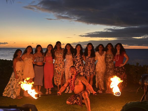 YLHS Girls Basketball with the fire dancer before the traditional fire performance in Hawaii.