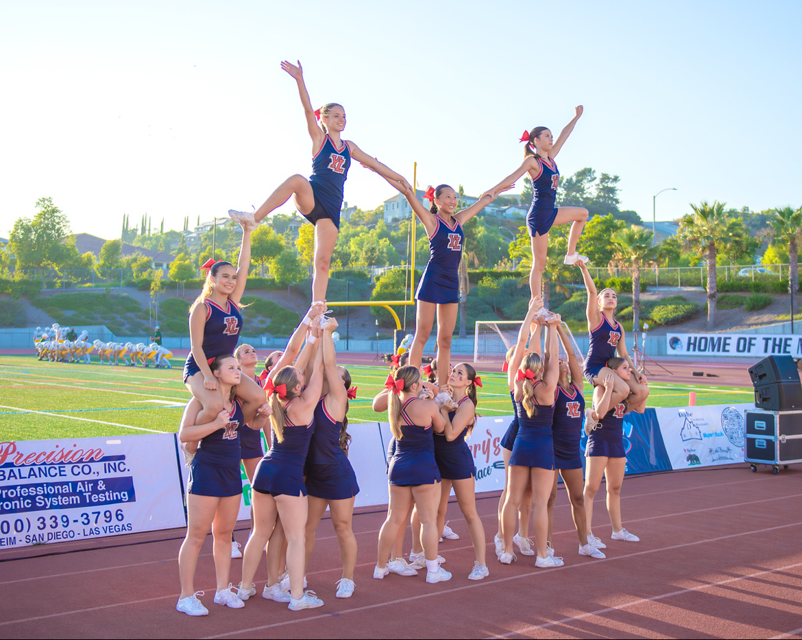 Varsity Cheer performing at the first home football game, coached by Stacy Shube.
