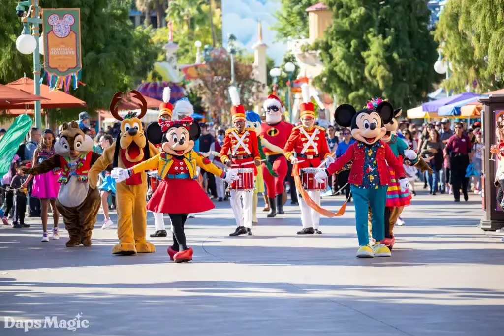 Mickey & his friends happily strolling and dancing at the Christmas Fantasy Parade on Main Street at the Disneyland Park. 
