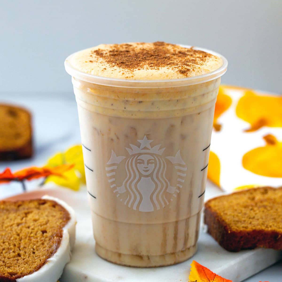 An iced Pumpkin Cream Chai from Starbucks, which is a blend of black tea, spices, and cold foam. 