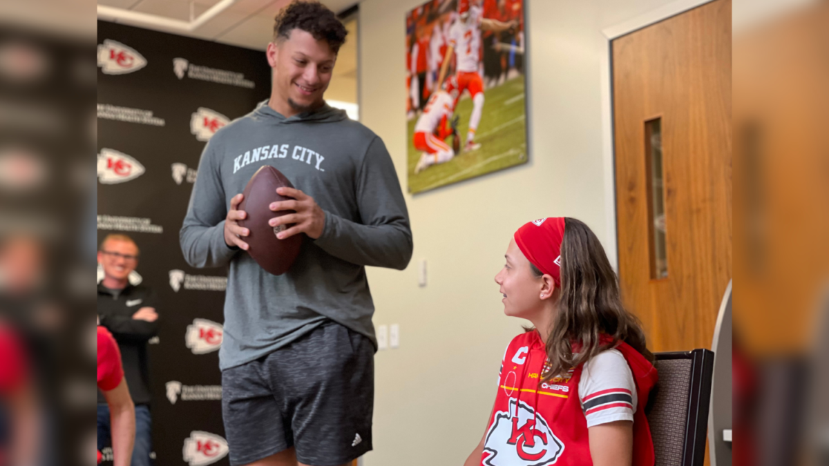 Myka sits excitedly next to the Chiefs' quarterback, Patrick Mahomes.